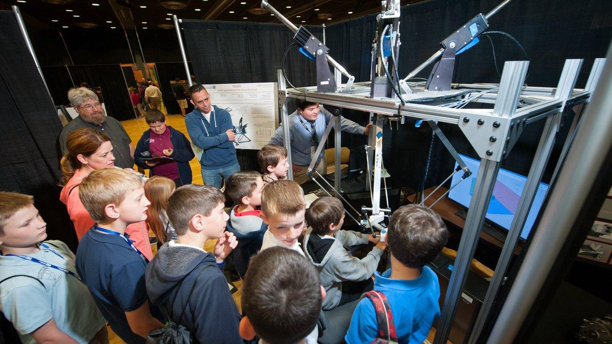 A group of young local students view a demo at the annual engineering expo.