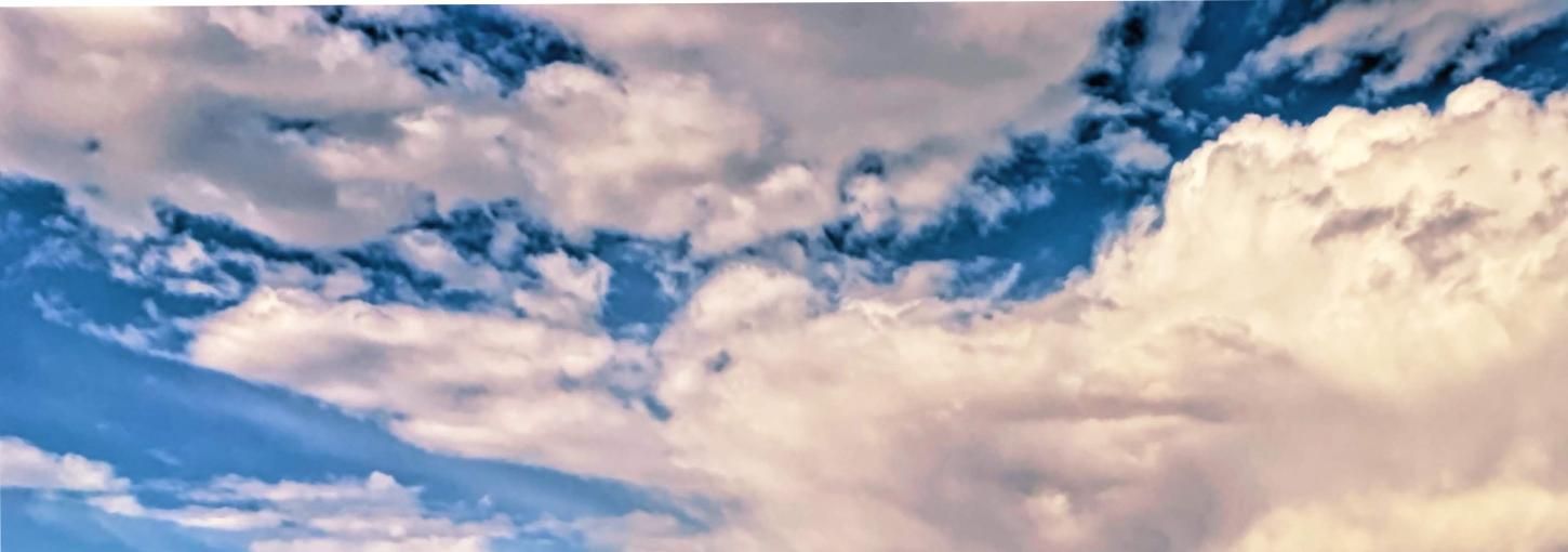 White clouds float in a blue sky.